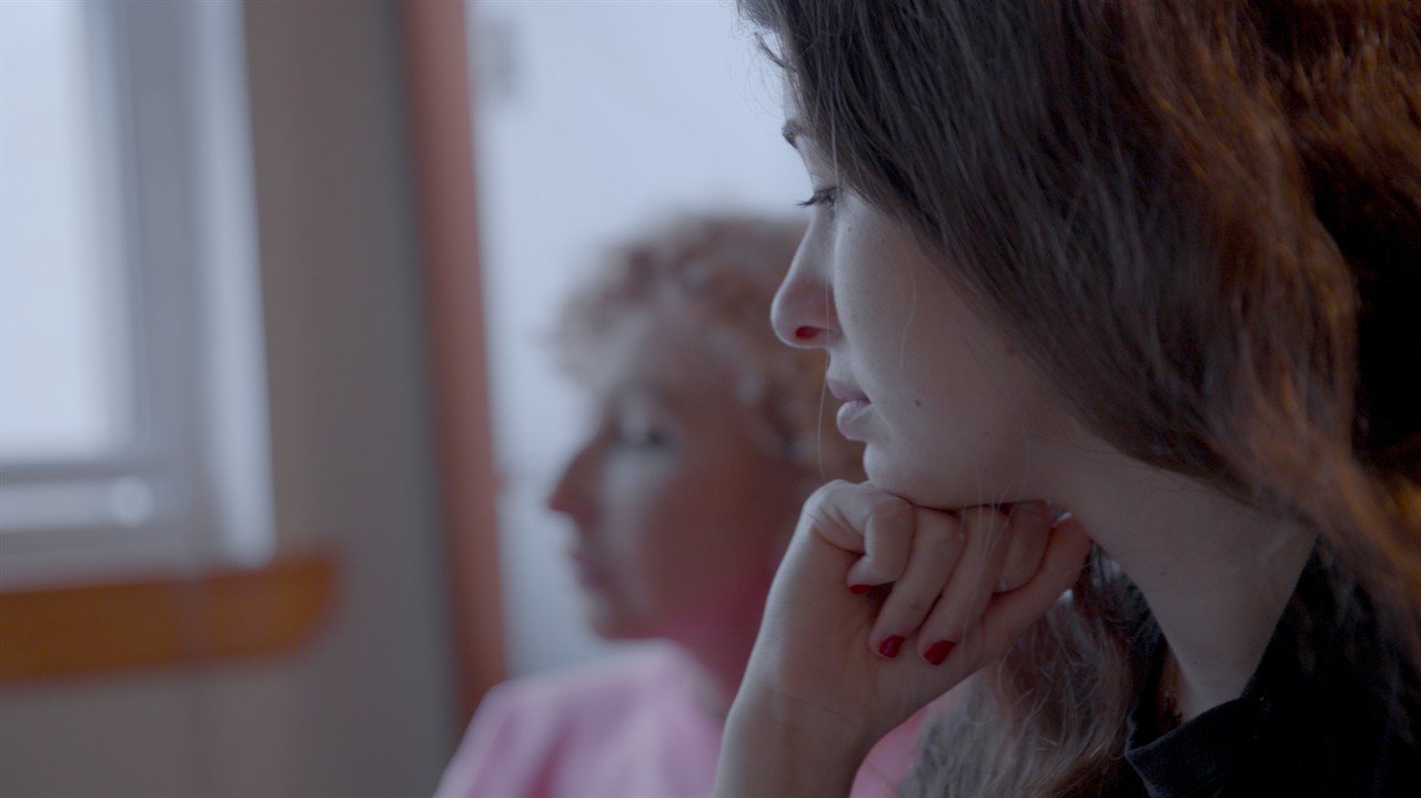 Close up of a woman with her hand on her chin